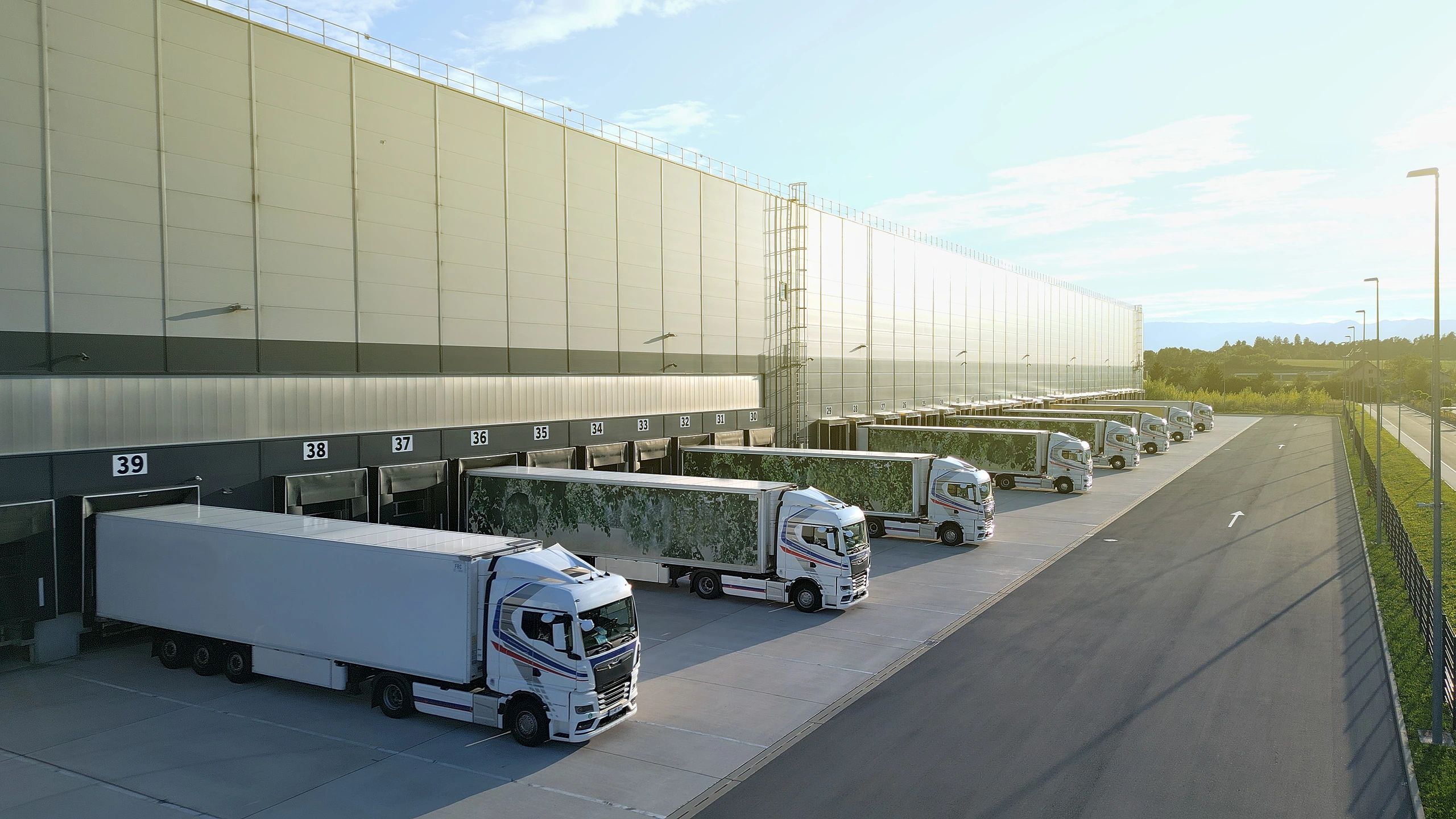 Trucks lined up at loading bays in a modern distribution warehouse